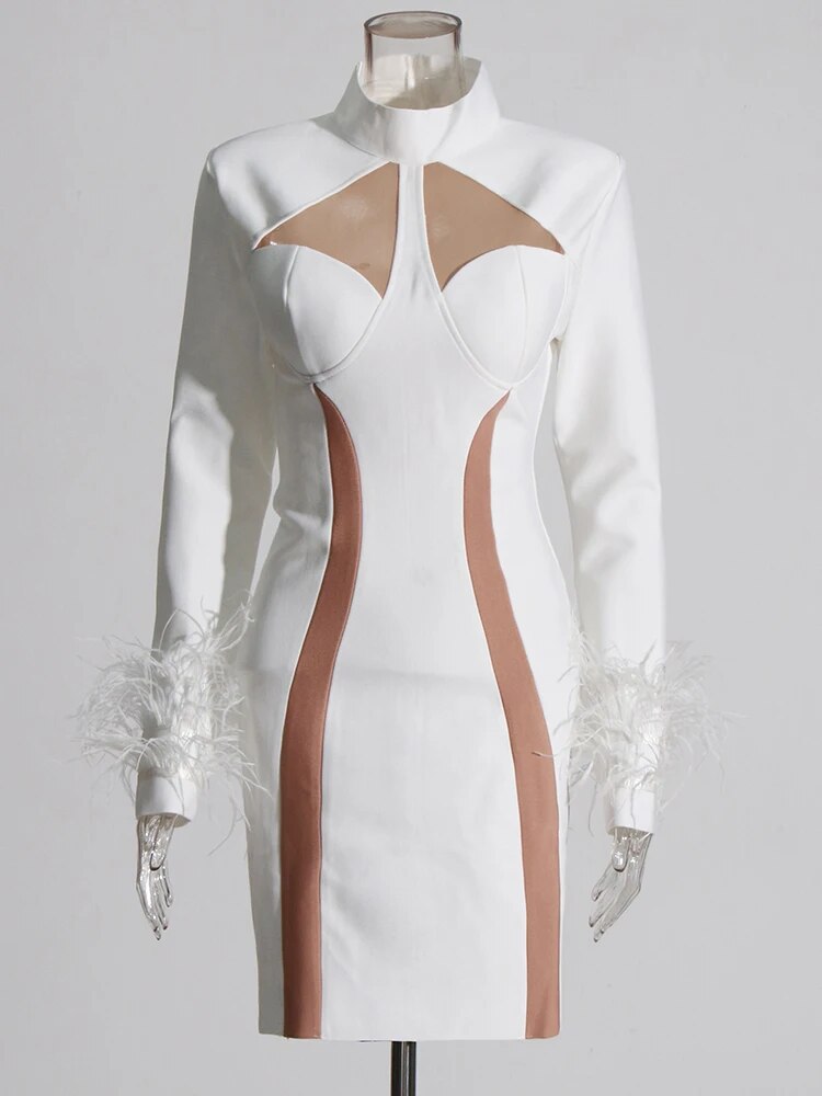 White mini dress with mesh cutouts and feather trims in cuffs