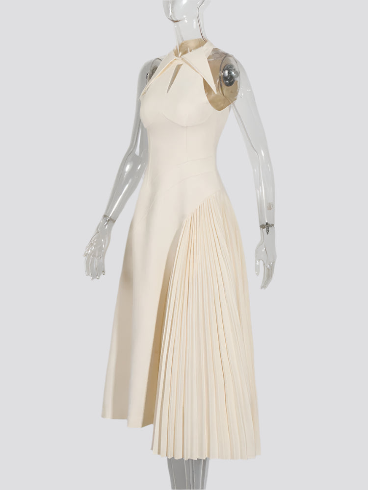 Chic pleated dress styled with heels for a wedding guest look
